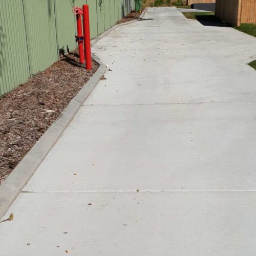 Continuous concrete driveway edging kerb with garden bed
