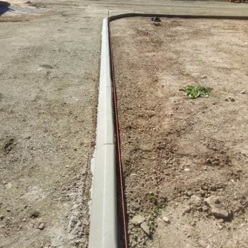 Continuous concrete driveway edging kerb on rural property