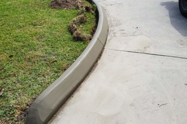 Continuous concrete driveway edging kerb after being repaired