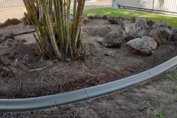 Continuous concrete garden edging kerb after being repaired